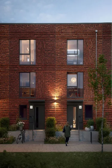 Eingangsbereich von zwei nebeneinander liegenden Townhouses in der blauen Stunde.